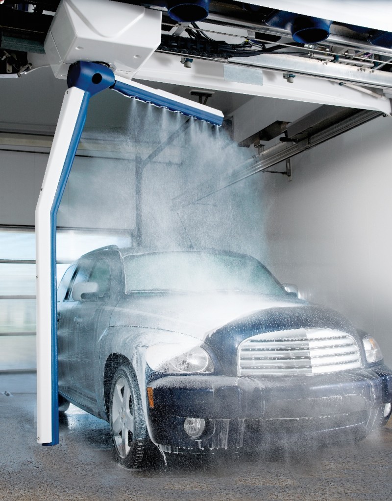 A car is being sprayed with soap by an automatic car wash machine